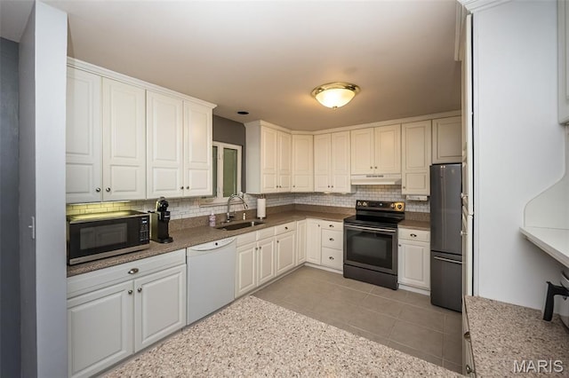 3644 Crestview Dr, Hillsboro, MO 63050 - kitchen featuring stainless steel appliances, backsplash, white cabinets, and under cabinet range hood