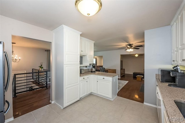 3644 Crestview Dr, Hillsboro, MO 63050 - kitchen with ceiling fan, stainless steel fridge, white cabinetry, and a peninsula