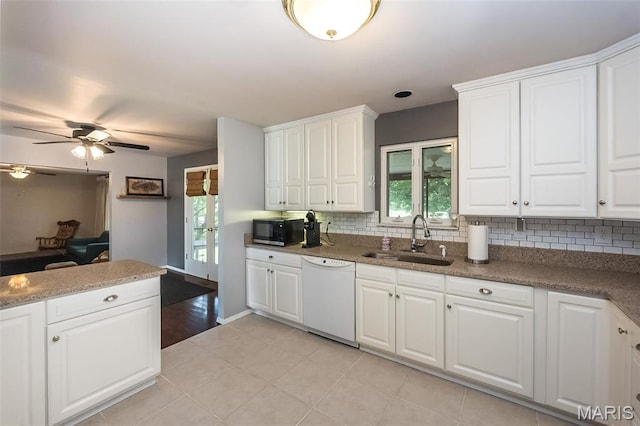 3644 Crestview Dr, Hillsboro, MO 63050 - kitchen featuring white dishwasher, stainless steel microwave, plenty of natural light, and backsplash