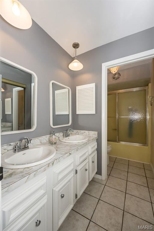 3644 Crestview Dr, Hillsboro, MO 63050 - bathroom featuring double vanity, tile patterned floors, shower / bath combination with glass door, and vaulted ceiling
