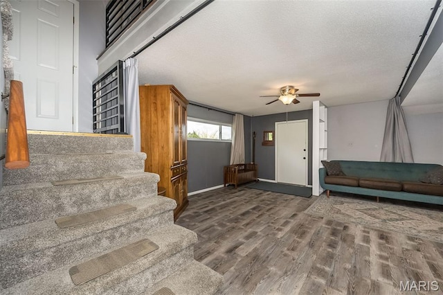 3644 Crestview Dr, Hillsboro, MO 63050 - staircase featuring a ceiling fan, wood finished floors, and a textured ceiling