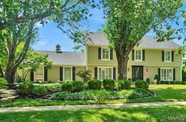 1571 Yarmouth Point Dr, Chesterfield, MO 63017 - colonial house featuring a front yard, a shingled roof, and a chimney