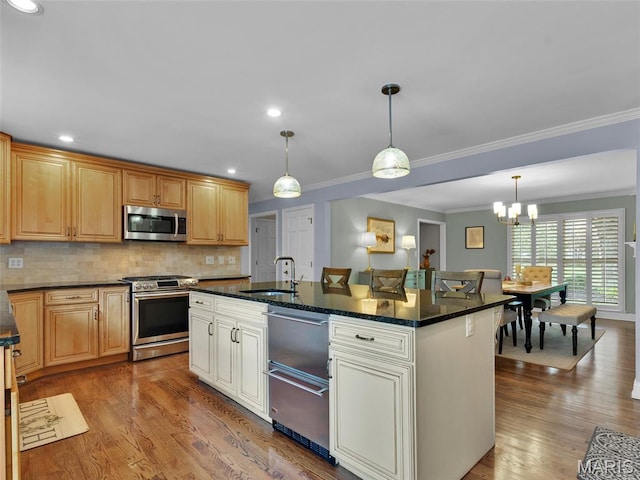 1571 Yarmouth Point Dr, Chesterfield, MO 63017 - kitchen with stainless steel appliances, ornamental molding, a chandelier, wood finished floors, and backsplash