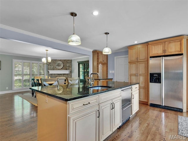 1571 Yarmouth Point Dr, Chesterfield, MO 63017 - kitchen featuring stainless steel appliances, ornamental molding, healthy amount of natural light, light wood-style flooring, and dark stone countertops