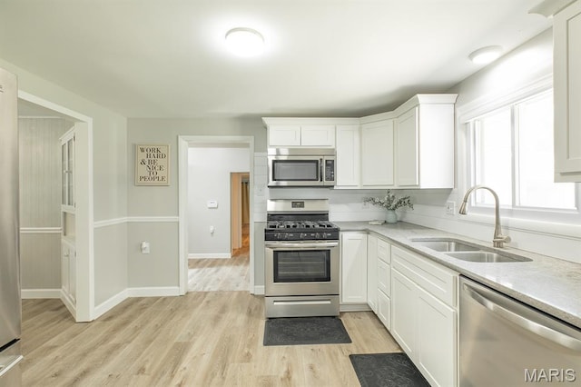 250 Hi Pointe Pl, East Alton, IL 62024 - kitchen featuring appliances with stainless steel finishes, light wood-style flooring, white cabinetry, and light stone countertops
