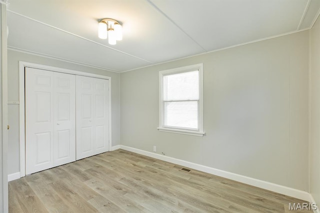 250 Hi Pointe Pl, East Alton, IL 62024 - unfurnished bedroom with light wood finished floors, crown molding, and a closet