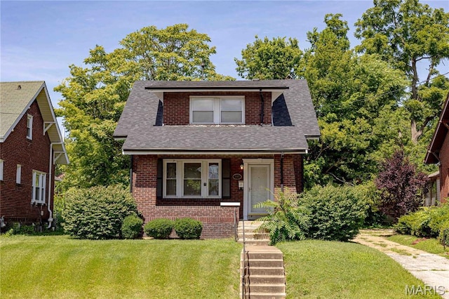 1105 Pennsylvania Ave, Saint Louis, MO 63130 - view of front of property with a shingled roof, brick siding, and a front yard