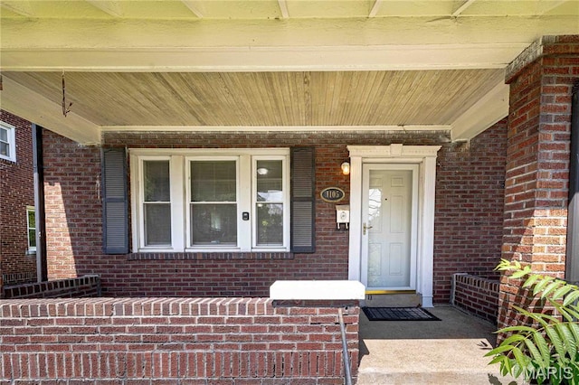 1105 Pennsylvania Ave, Saint Louis, MO 63130 - doorway to property with covered porch and brick siding