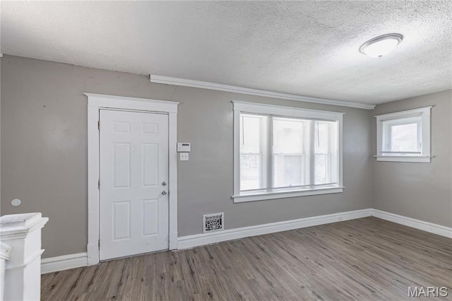 1105 Pennsylvania Ave, Saint Louis, MO 63130 - foyer entrance featuring a textured ceiling and wood finished floors