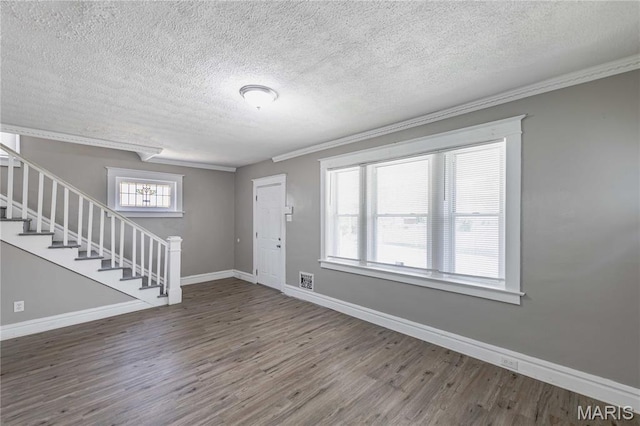 1105 Pennsylvania Ave, Saint Louis, MO 63130 - foyer entrance with wood finished floors, a textured ceiling, ornamental molding, and stairway