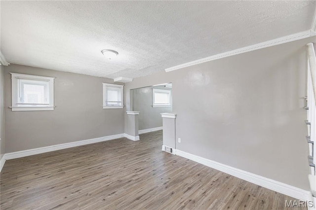 1105 Pennsylvania Ave, Saint Louis, MO 63130 - unfurnished room with a textured ceiling, light wood finished floors, and ornamental molding