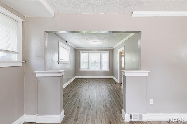 1105 Pennsylvania Ave, Saint Louis, MO 63130 - empty room featuring ornamental molding, wood finished floors, and a textured ceiling