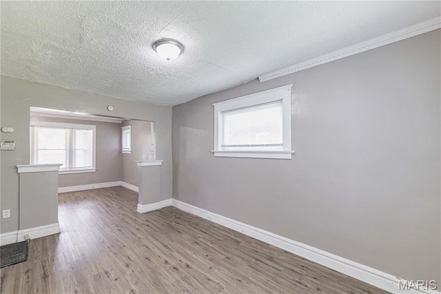 1105 Pennsylvania Ave, Saint Louis, MO 63130 - unfurnished room with a textured ceiling and wood finished floors