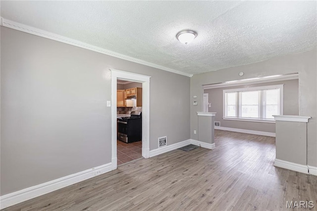 1105 Pennsylvania Ave, Saint Louis, MO 63130 - unfurnished room featuring wood finished floors, a textured ceiling, and ornamental molding