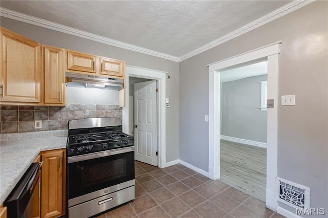 1105 Pennsylvania Ave, Saint Louis, MO 63130 - kitchen featuring stainless steel appliances, under cabinet range hood, light countertops, backsplash, and crown molding