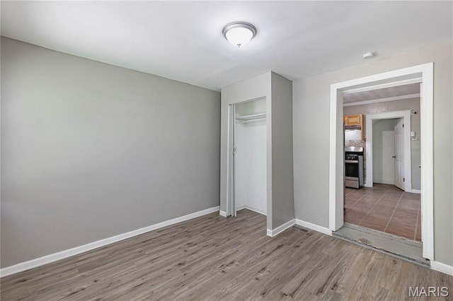 1105 Pennsylvania Ave, Saint Louis, MO 63130 - unfurnished bedroom with wood finished floors and a closet
