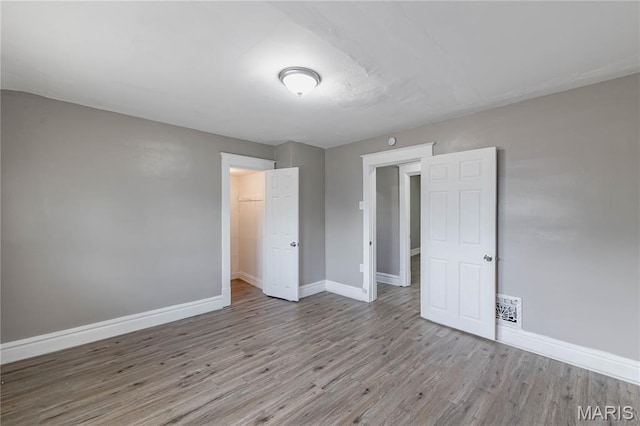 1105 Pennsylvania Ave, Saint Louis, MO 63130 - unfurnished bedroom featuring wood finished floors and a closet