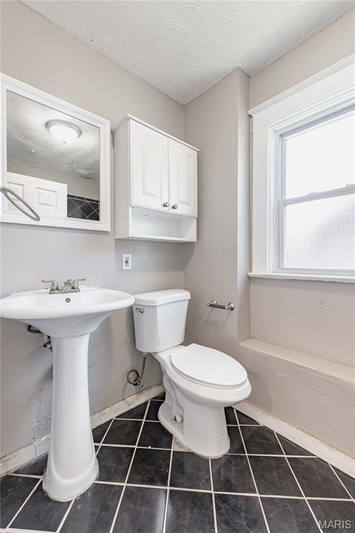 1105 Pennsylvania Ave, Saint Louis, MO 63130 - half bathroom with toilet and tile patterned flooring