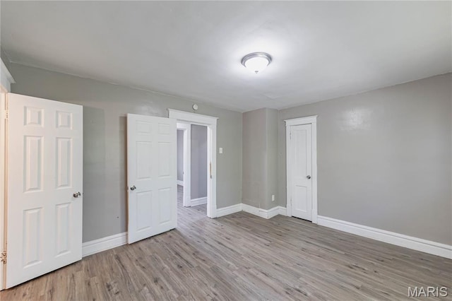 1105 Pennsylvania Ave, Saint Louis, MO 63130 - unfurnished bedroom with wood finished floors and a closet