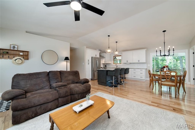 8870 State Road Nn, Cedar Hill, MO 63016 - living room featuring a chandelier, light wood-style floors, ceiling fan, and lofted ceiling
