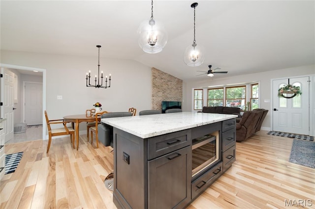 8870 State Road Nn, Cedar Hill, MO 63016 - kitchen featuring ceiling fan, stainless steel microwave, open floor plan, light wood-style floors, and lofted ceiling