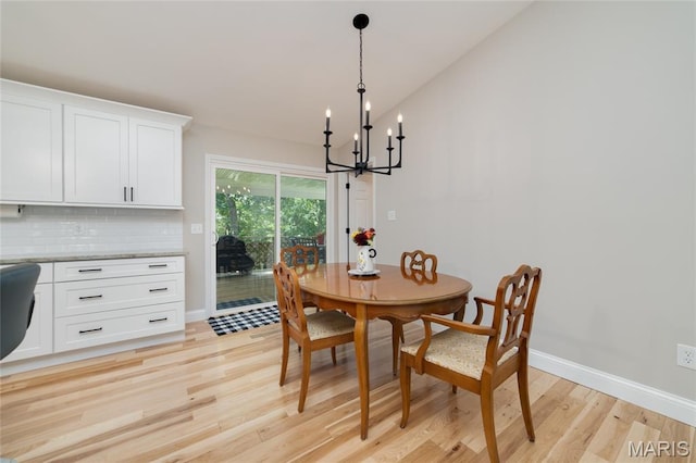 8870 State Road Nn, Cedar Hill, MO 63016 - dining area with a chandelier, light wood-style flooring, and vaulted ceiling