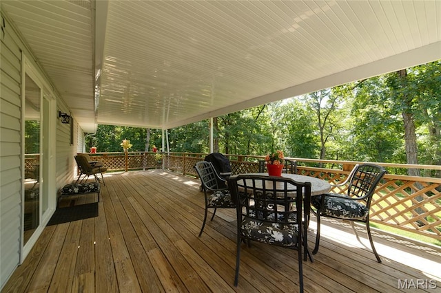 8870 State Road Nn, Cedar Hill, MO 63016 - wooden terrace with outdoor dining area and view of scattered trees