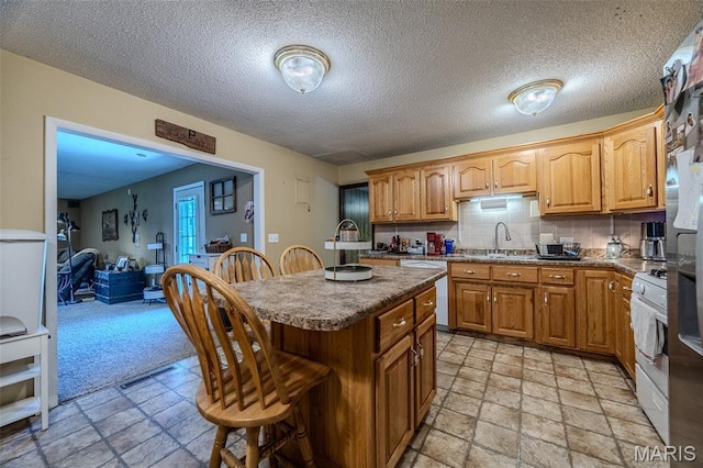 30053 Emily Ln, Lebanon, MO 65536 - kitchen with white appliances, stone tile floors, a breakfast bar area, a center island, and a textured ceiling