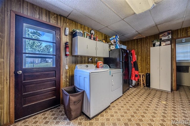 30053 Emily Ln, Lebanon, MO 65536 - laundry room featuring cabinet space, wood walls, and washing machine and dryer