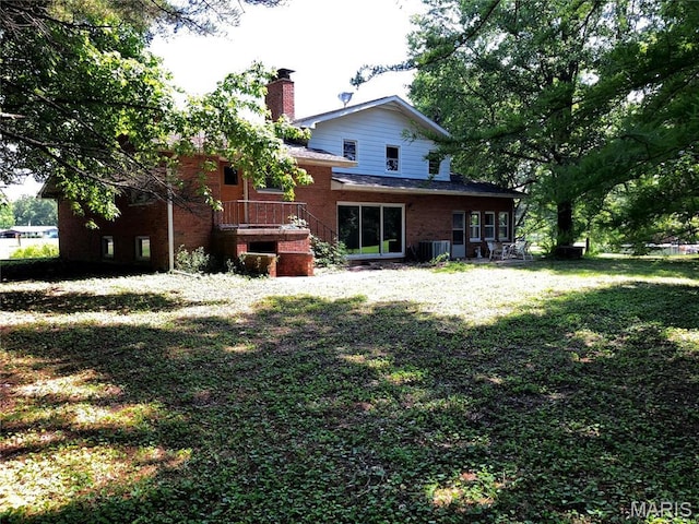 4612 Wood Duck Rd, Pinckneyville, IL 62274 - back of house with a chimney, brick siding, and a lawn
