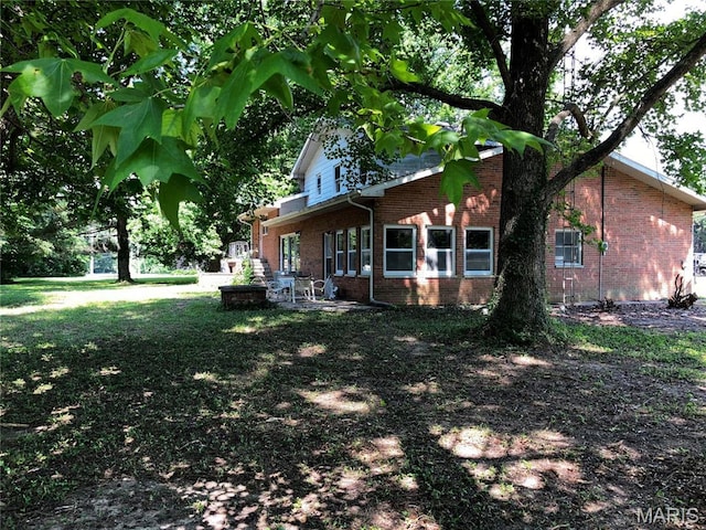 4612 Wood Duck Rd, Pinckneyville, IL 62274 - view of home's exterior with brick siding, a patio, and a lawn