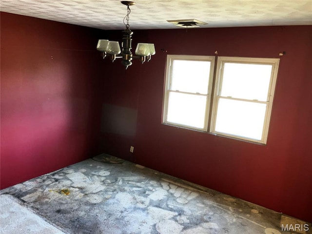 4612 Wood Duck Rd, Pinckneyville, IL 62274 - empty room with a chandelier, carpet floors, and a textured ceiling