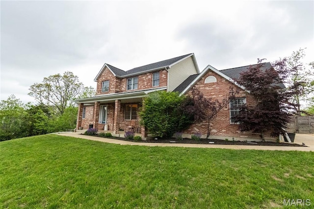11907 Pine Forest Dr, Rolla, MO 65401 - view of front of home with brick siding, a front yard, and a porch