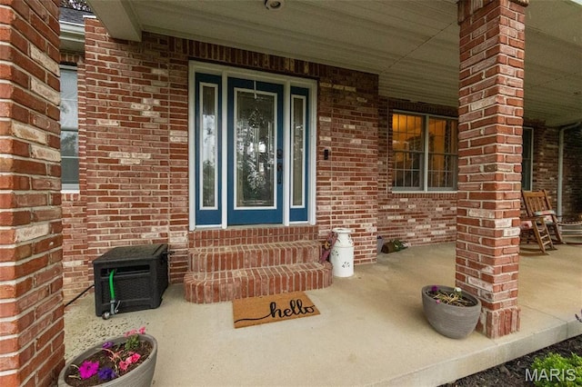 11907 Pine Forest Dr, Rolla, MO 65401 - view of exterior entry with covered porch and brick siding