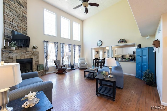 11907 Pine Forest Dr, Rolla, MO 65401 - living area with a ceiling fan, a fireplace, high vaulted ceiling, hardwood / wood-style floors, and healthy amount of natural light
