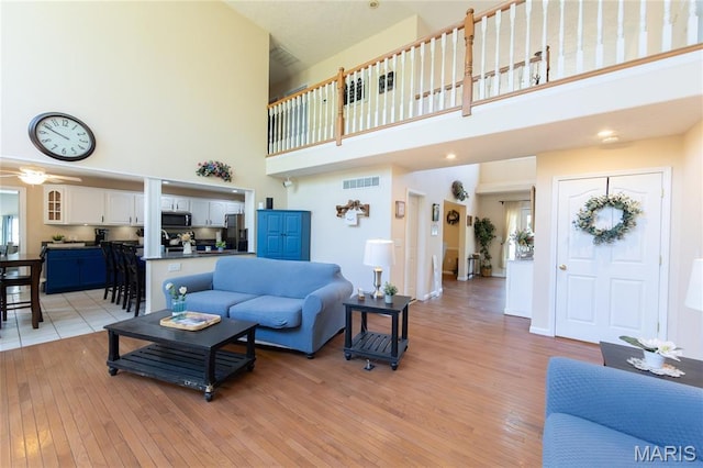 11907 Pine Forest Dr, Rolla, MO 65401 - living room with a high ceiling and light wood-style flooring