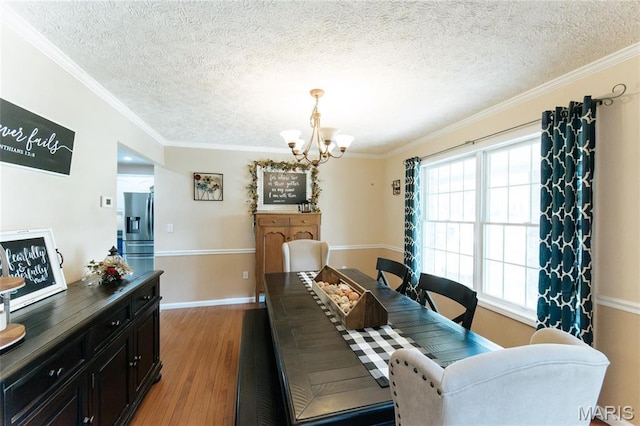 11907 Pine Forest Dr, Rolla, MO 65401 - dining space with a chandelier, a textured ceiling, light wood finished floors, and crown molding
