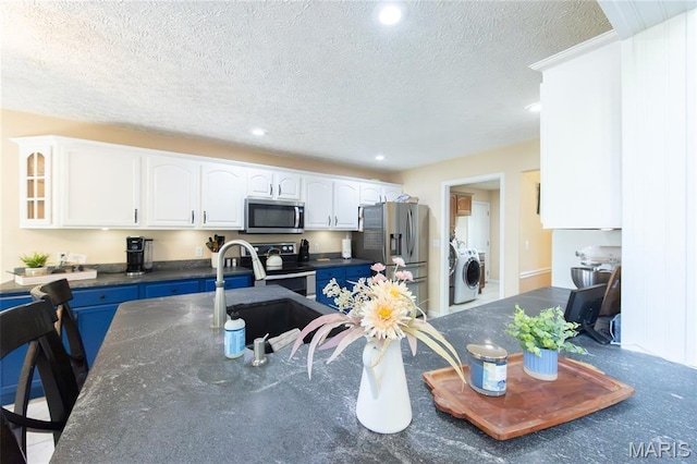 11907 Pine Forest Dr, Rolla, MO 65401 - kitchen with stainless steel appliances, white cabinetry, a textured ceiling, glass insert cabinets, and recessed lighting