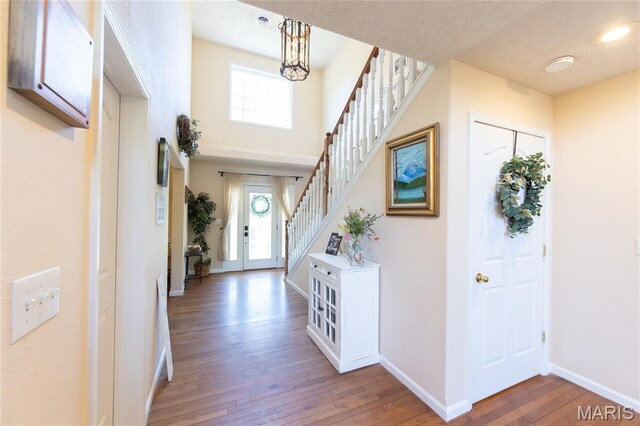 11907 Pine Forest Dr, Rolla, MO 65401 - foyer with hardwood / wood-style flooring, stairway, healthy amount of natural light, and a chandelier