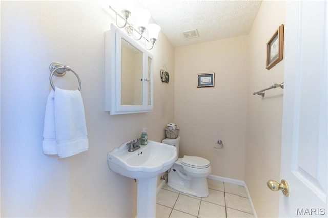 11907 Pine Forest Dr, Rolla, MO 65401 - half bathroom featuring tile patterned floors and a textured ceiling