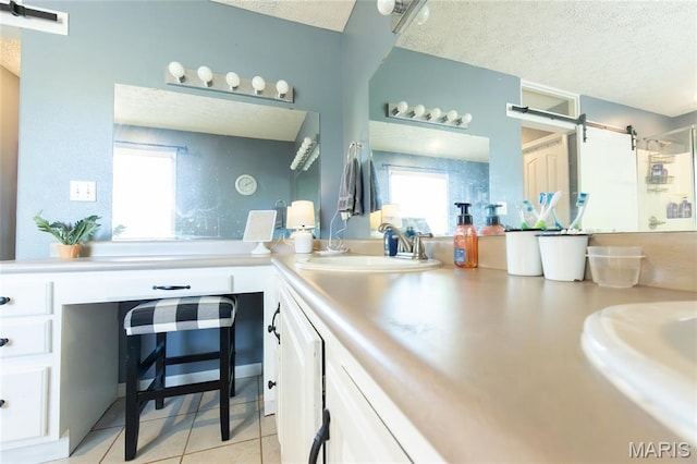 11907 Pine Forest Dr, Rolla, MO 65401 - bathroom with a textured ceiling, double vanity, tile patterned floors, and a shower