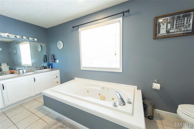 11907 Pine Forest Dr, Rolla, MO 65401 - bathroom with double vanity, tile patterned flooring, a whirlpool tub, and a textured ceiling