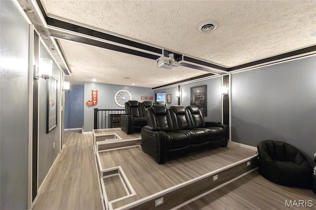 11907 Pine Forest Dr, Rolla, MO 65401 - home theater room with a textured ceiling, wood finished floors, and beamed ceiling