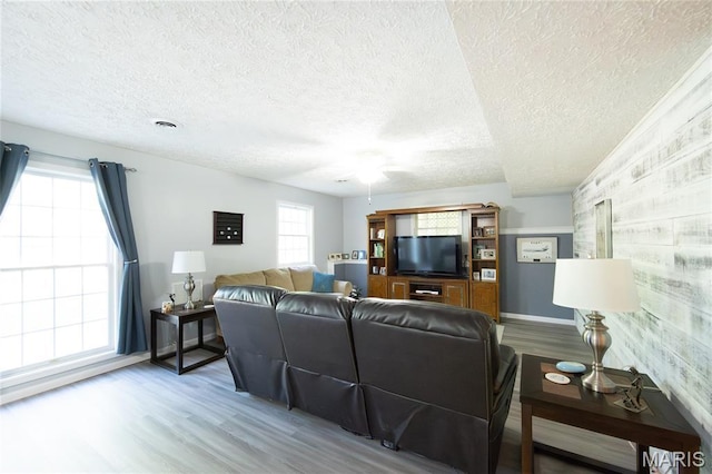 11907 Pine Forest Dr, Rolla, MO 65401 - living area with wood finished floors, a textured ceiling, and a ceiling fan