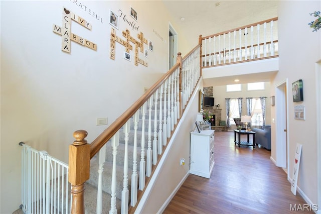 11907 Pine Forest Dr, Rolla, MO 65401 - stairs with a towering ceiling and wood finished floors