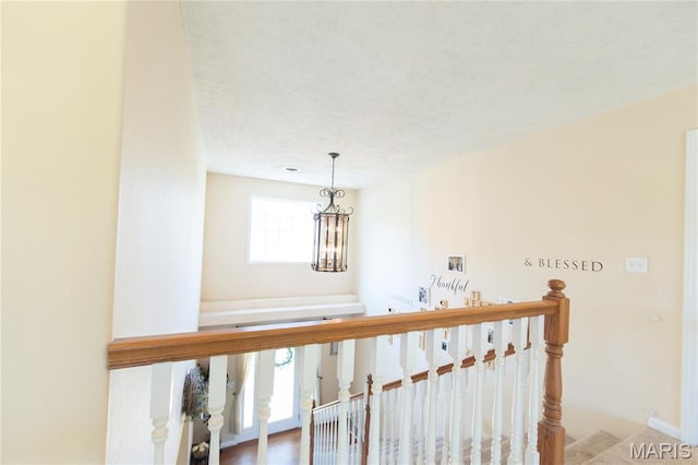 11907 Pine Forest Dr, Rolla, MO 65401 - corridor with a textured ceiling and an upstairs landing