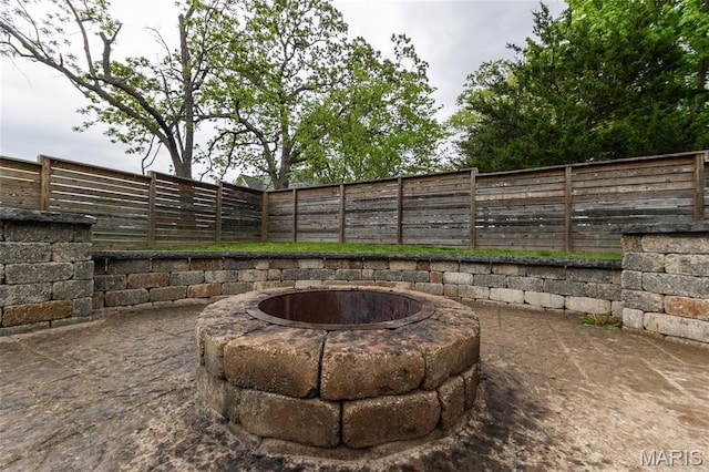 11907 Pine Forest Dr, Rolla, MO 65401 - fenced backyard with an outdoor fire pit and a patio area