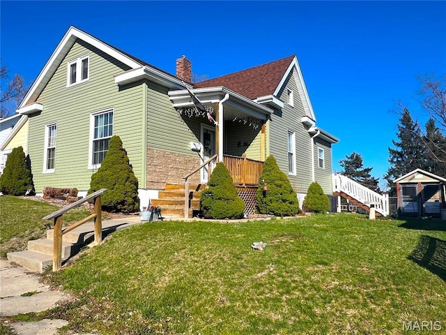 606 Olive St, Hannibal, MO 63401 - bungalow-style house featuring a chimney, a front lawn, and stairway