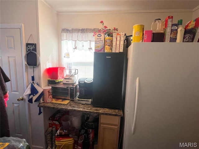 606 Olive St, Hannibal, MO 63401 - kitchen with freestanding refrigerator and ornamental molding