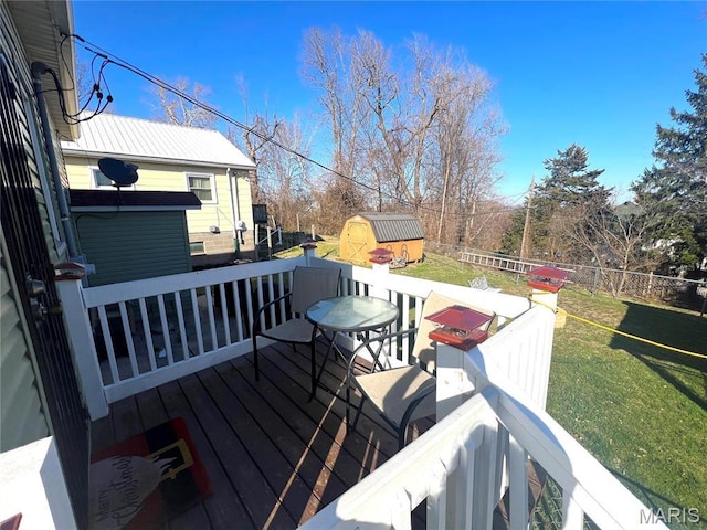 606 Olive St, Hannibal, MO 63401 - wooden terrace featuring a storage unit and a fenced backyard